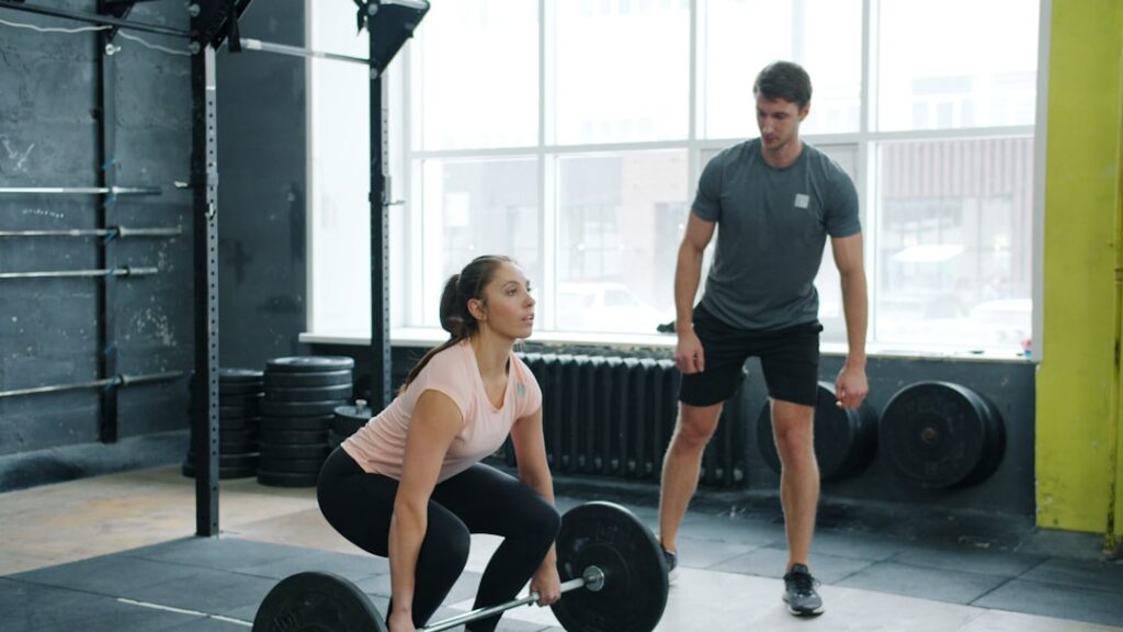 woman confidently lifting weights in a supportive gym environment
